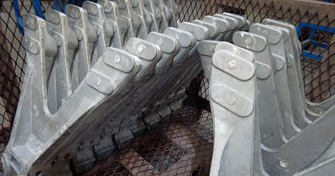 Group of cast parts in a metal bin